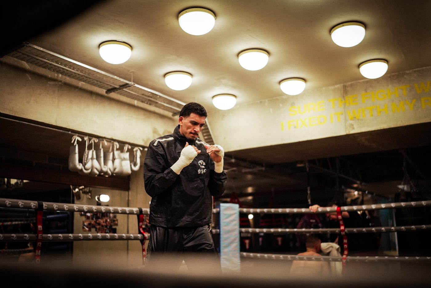 Hamzah Sheeraz shadow boxing in a sauna suit in the ring